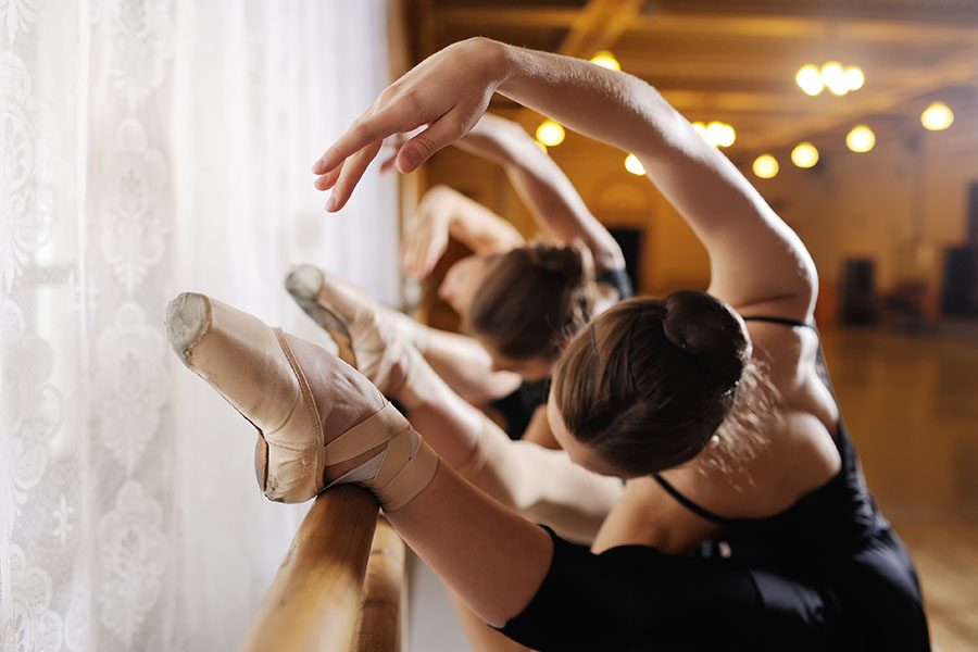 Specialized Business Insurance - Line Of Young Girls Practicing Ballet On Barre In Dance Studio
